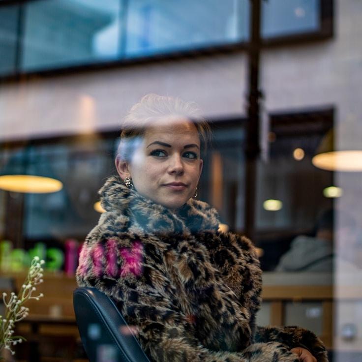 Keira Malik, Lead Design Curator at Oak Paper Studio, reviewing corporate floral arrangements
